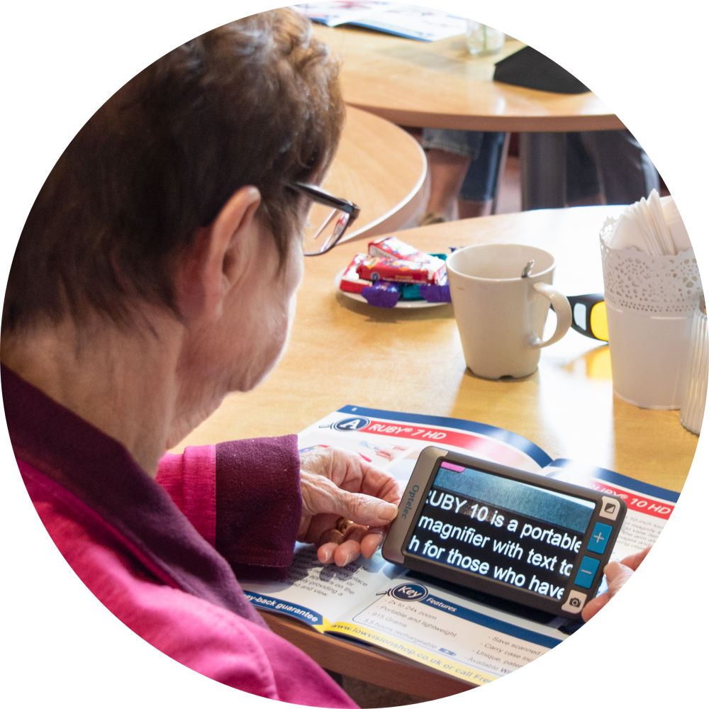 Client using a digital magnifier to read a maganzine 