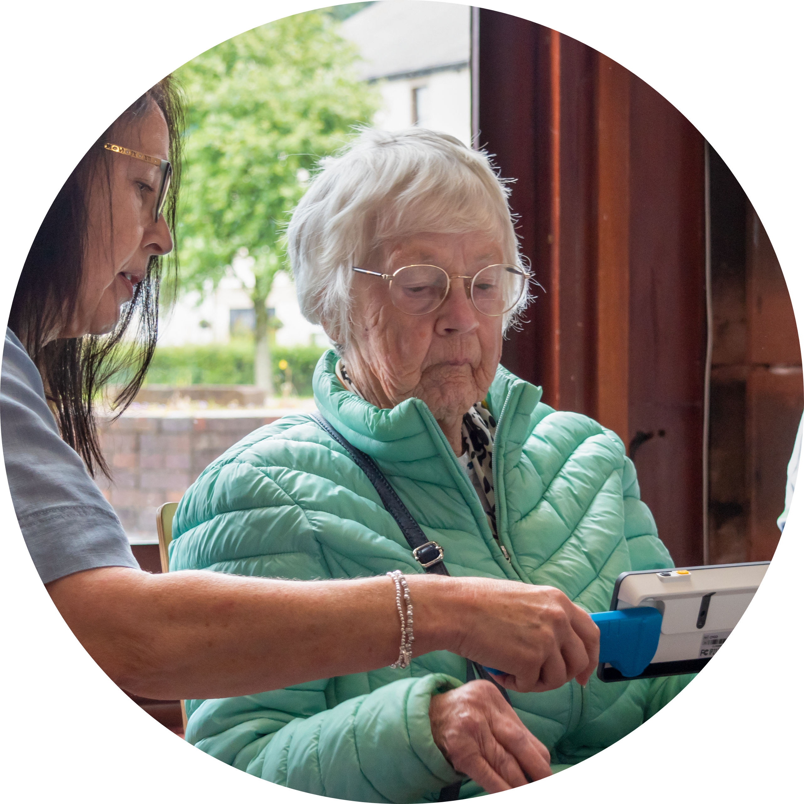 Social group members practicing using a digital magnifier