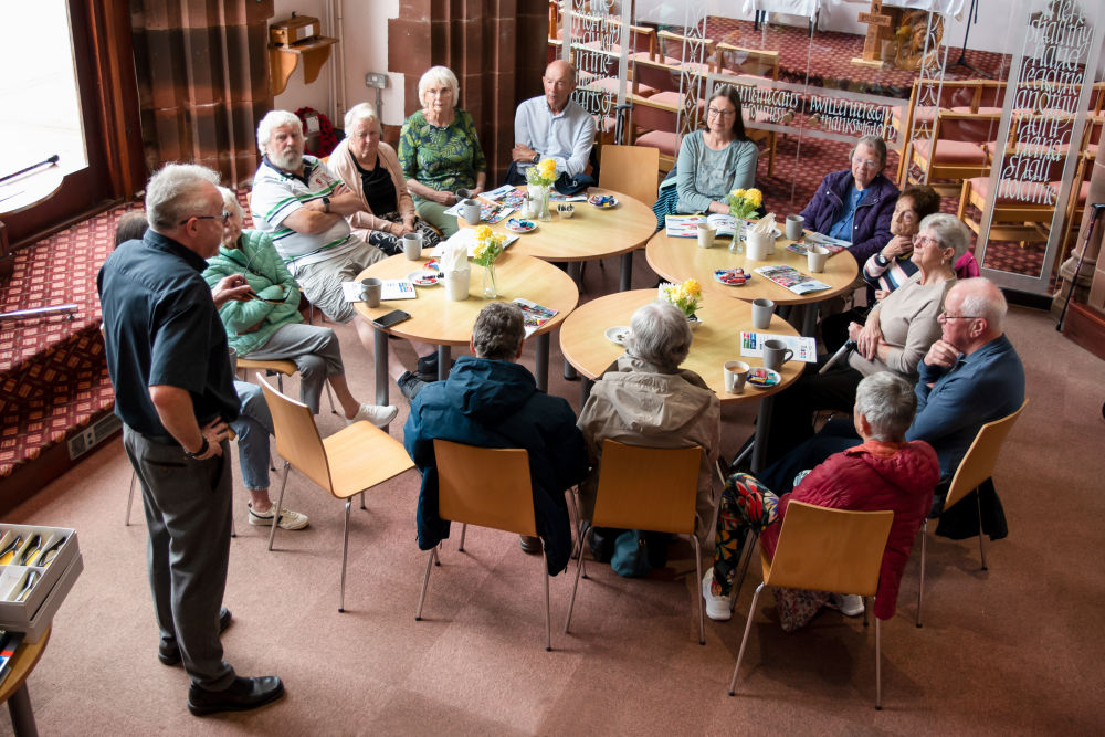Social group members listening to a guest speaker
